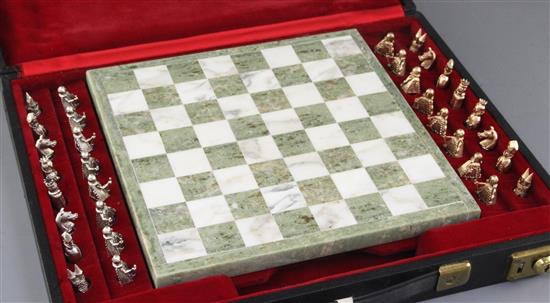 A cased 1960s chess set with a white and green marble chess board and thirty two 9ct gold chess pieces, in white and yellow gold,